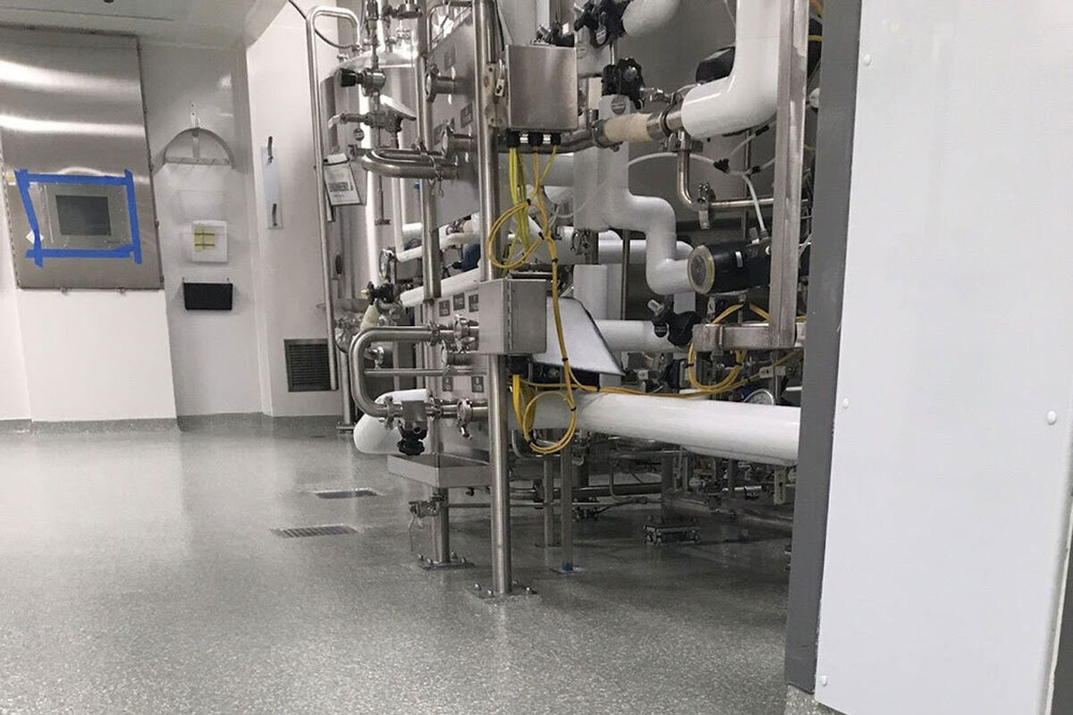 Machine in an industrial facility. How Does Industrial Flooring Solve Compliance Issues in Pharmaceutical Facilities?