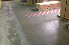 Damaged concrete floor in a warehouse 6 Signs Your Warehouse Needs Concrete Floor Resurfacing