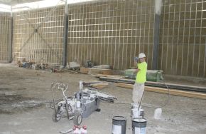 Man working on an industrial building. Operations Checklist: Keeping Your Industrial Floors 100% Safe and Durable