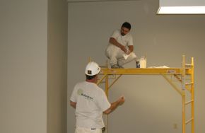 Two men painting. Why Service-Focused Industrial Painting and Industrial Flooring Companies Are More Successful